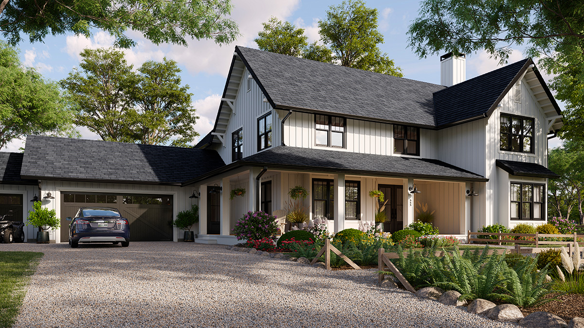 A modern farmhouse with stylish roofing, featuring white siding and dark trim, is surrounded by lush greenery. The two-story house has a covered porch, a gravel driveway, and a car parked outside the garage. A wooden fence and colorful flowers enhance the landscape.